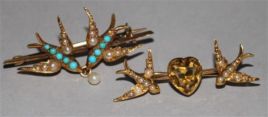 Two early 20th century gold and gem set swallow brooches, largest 1.5in.